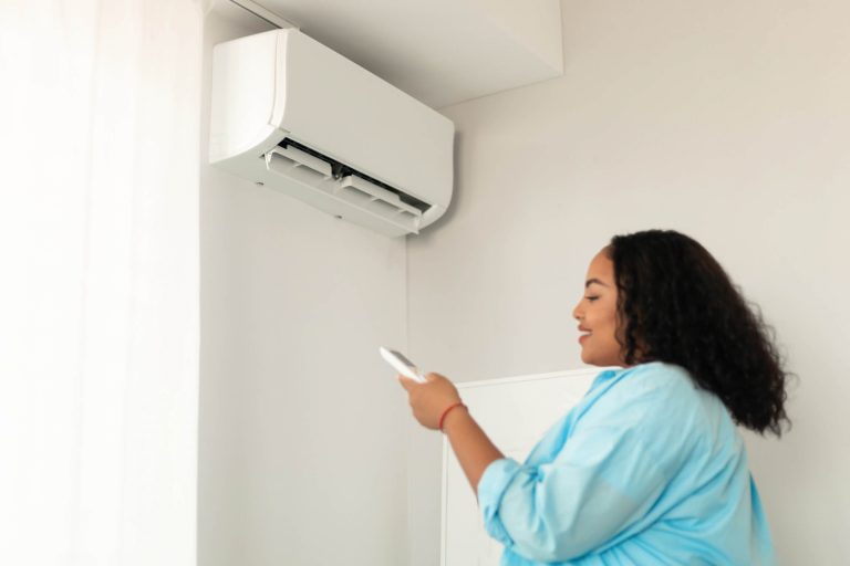 Home Climate Analyst from Shelter Air configuring a mini-split heat pump for efficient temperature management